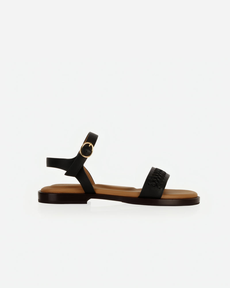 Side view of The Bohème Sandal Black in smooth leather. Sizes 5–12, wide available