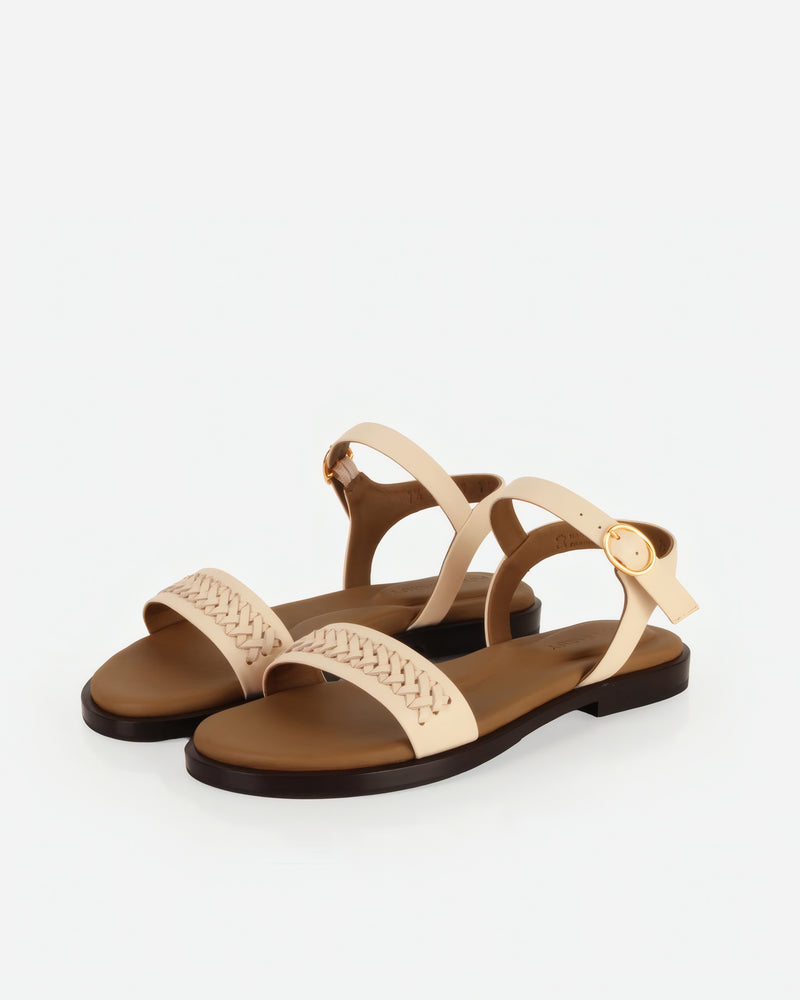 Pair of The Bohème Sandal Oat Milk in White smooth leather. Sizes 5–12