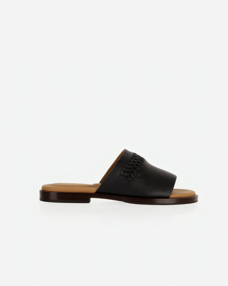 Side view of The Bohème Slide Black in smooth leather. Sizes 5–12