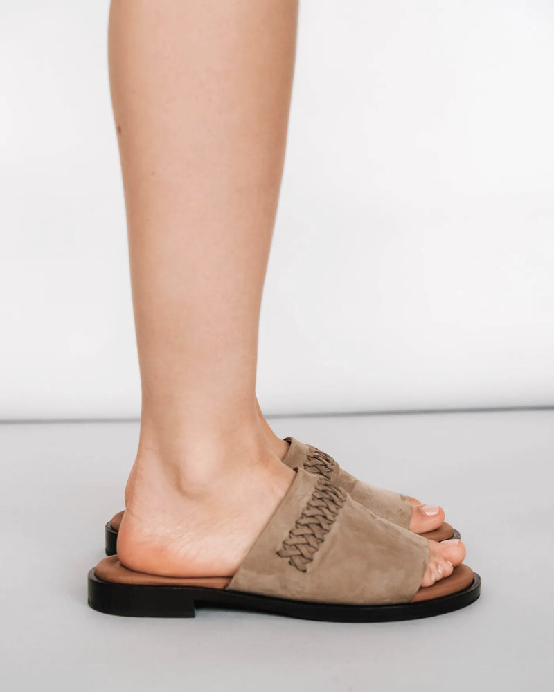 Nubuck slide sandals with woven detail, side view. The Bohème Slide Clay. Sizes 5–12.
