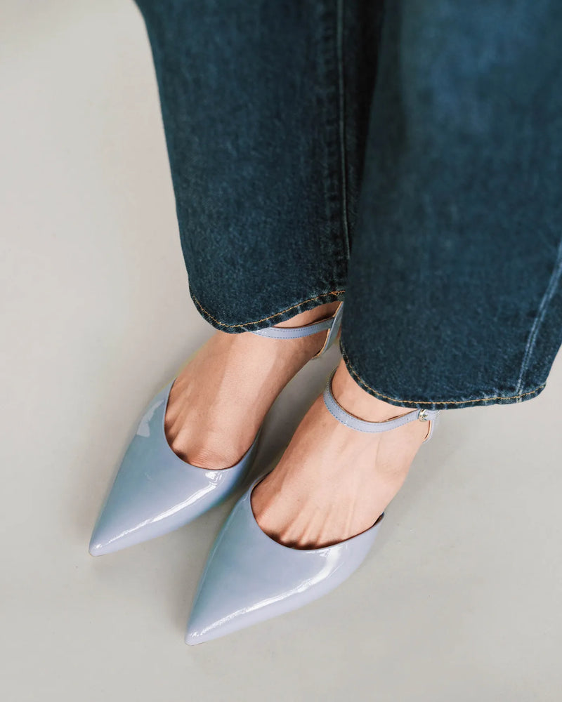 Horizon blue patent kitten heels with ankle strap and dark jeans. The Claire Kitten Heel Horizon Blue Patent. Sizes 5–12.