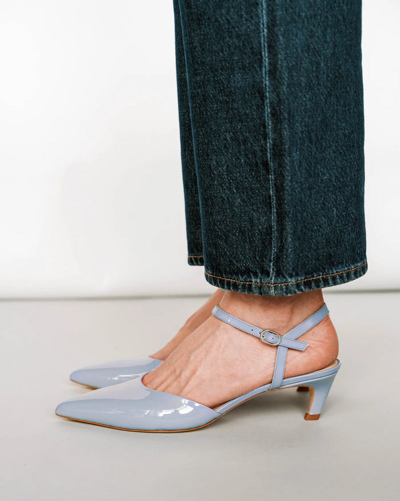 Horizon blue patent kitten heel, side profile with dark denim jeans. The Claire Kitten Heel Horizon Blue Patent. Sizes 5–12.