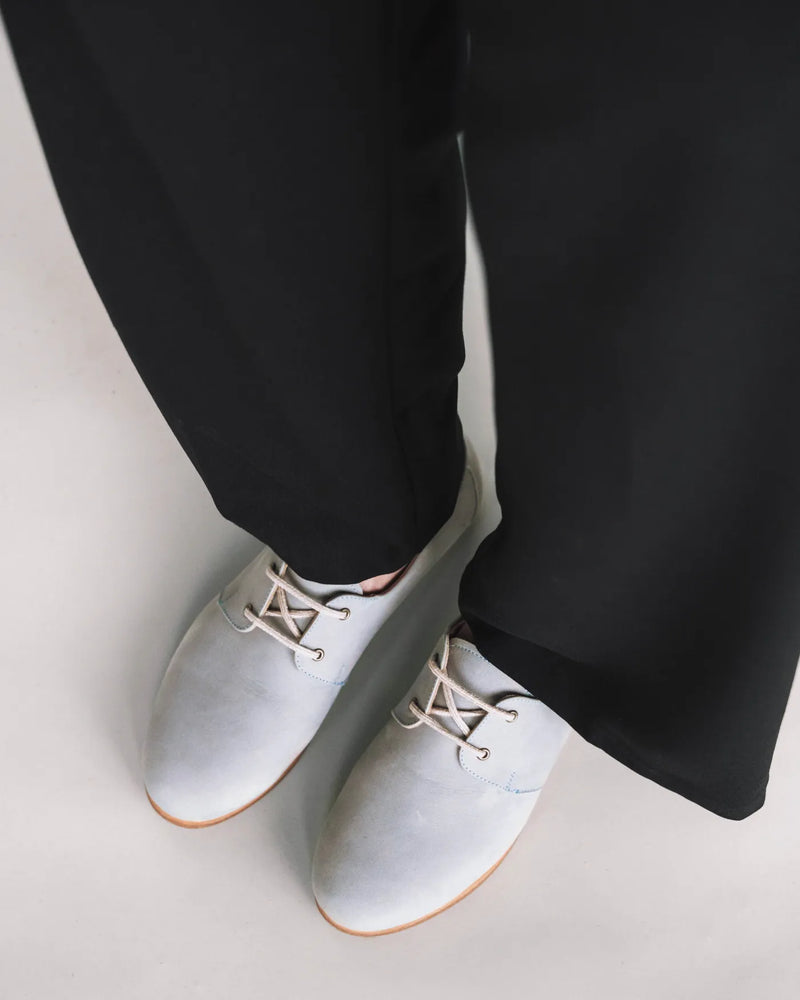 Suede oxfords worn with black wide-leg pants. The Eyelet Oxford 2.0 Bluebell. Sizes 5–12, available in wide.