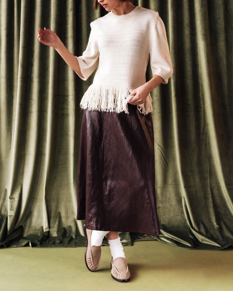 Woman in fringed top and satin skirt wearing loafers. The Laid Back Loafer Clay Nubuck. Sizes 5–12, available in wide.