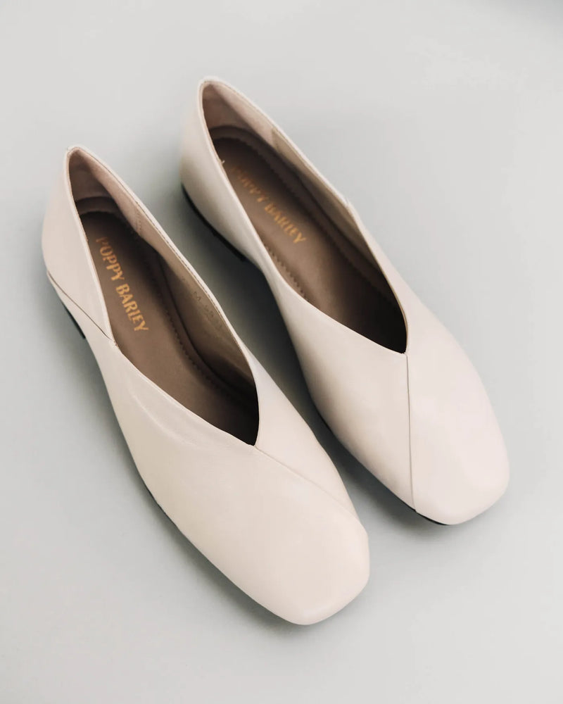 Leather square-toe flats on white surface, Poppy Barley insoles visible. The Marché Flat Porcelain. Sizes 5–12.