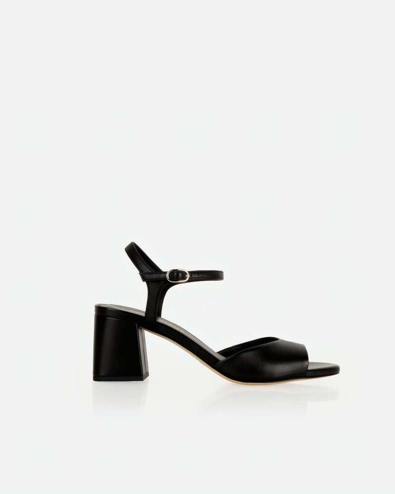 Heel detail of The Mila Heeled Sandal Black in smooth leather. Sizes 5–12