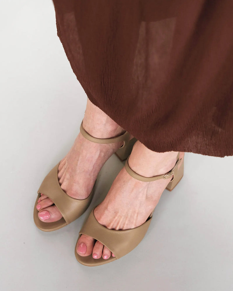 Leather heeled sandals with ankle strap, overhead view with burgundy dress. The Mila Heeled Sandal Halva. Sizes 5–12.
