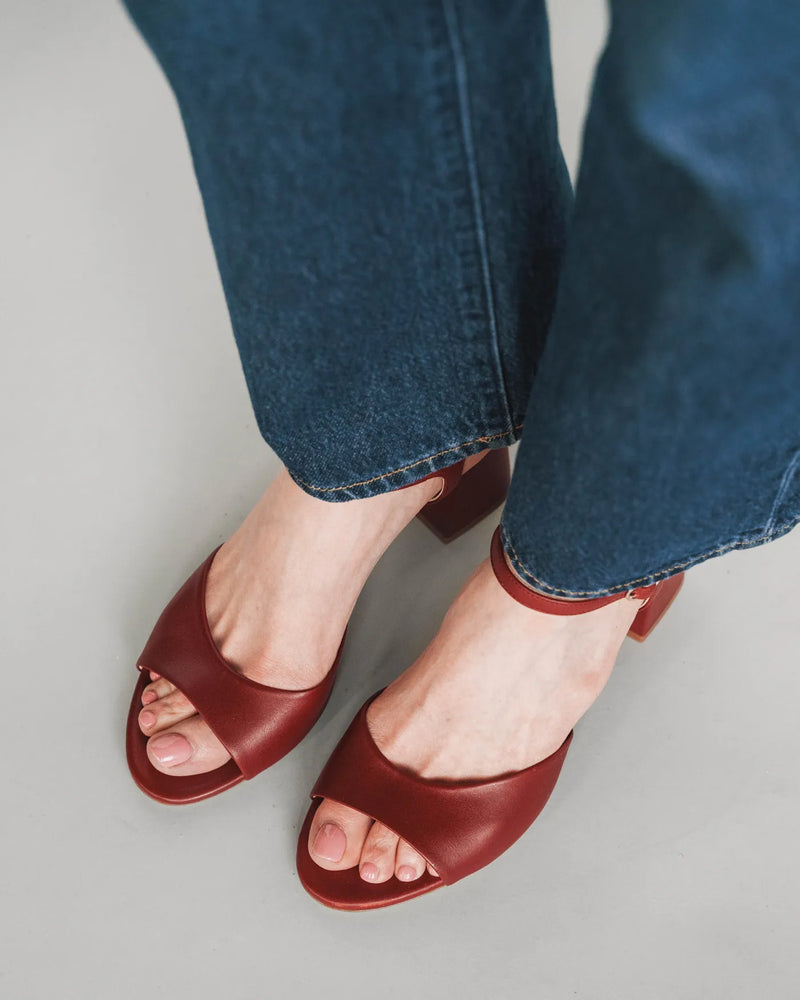 Leather block-heeled sandals with ankle strap, overhead view with dark jeans. The Mila Heeled Sandal Rioja. Sizes 5–12.