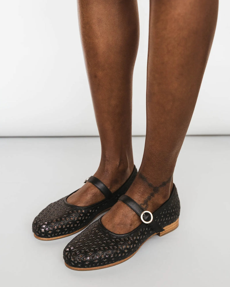 Black perforated Mary Janes with sheer socks. The Modern-Day Mary Jane Perforated Black. Sizes 5–12, available in wide.