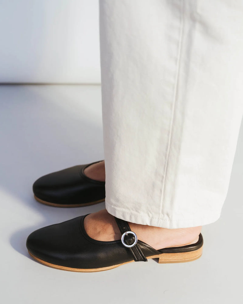 Leather slingback mule with Mary Jane strap, white trousers. The Modern-Day Mule Black. Sizes 5–12, available in wide.
