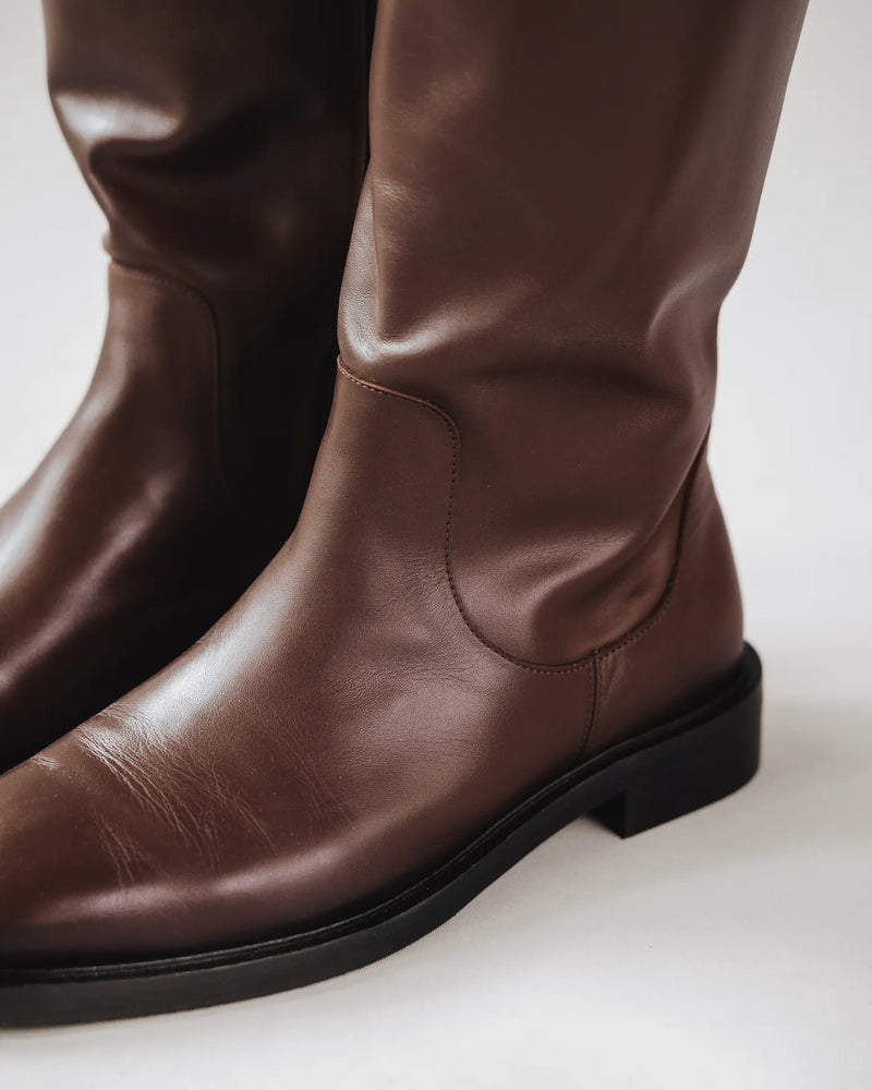 Close-up of espresso brown leather knee-high riding boot with round toe detail. The Riding Boot Espresso. Sizes 5–12.