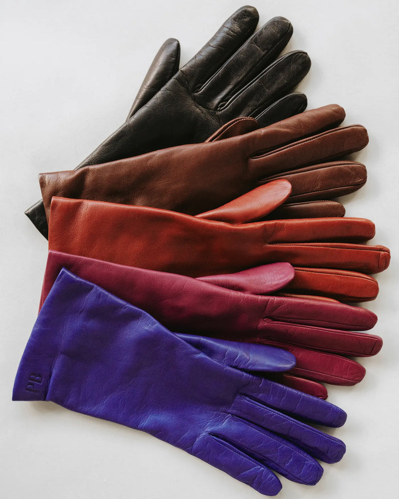 The Sleek Leather Glove Black, flat lay showing full glove range, espresso, brick, burgundy and royal blue