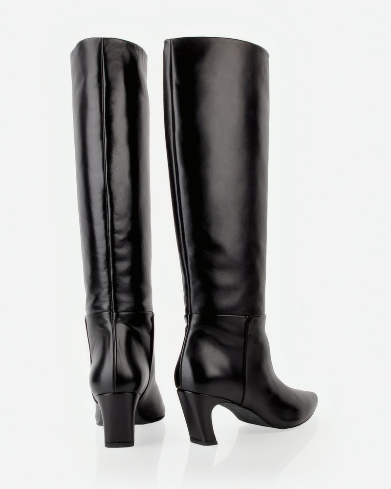 The Toujours Tall Boot Black in smooth leather. Sizes 5–12