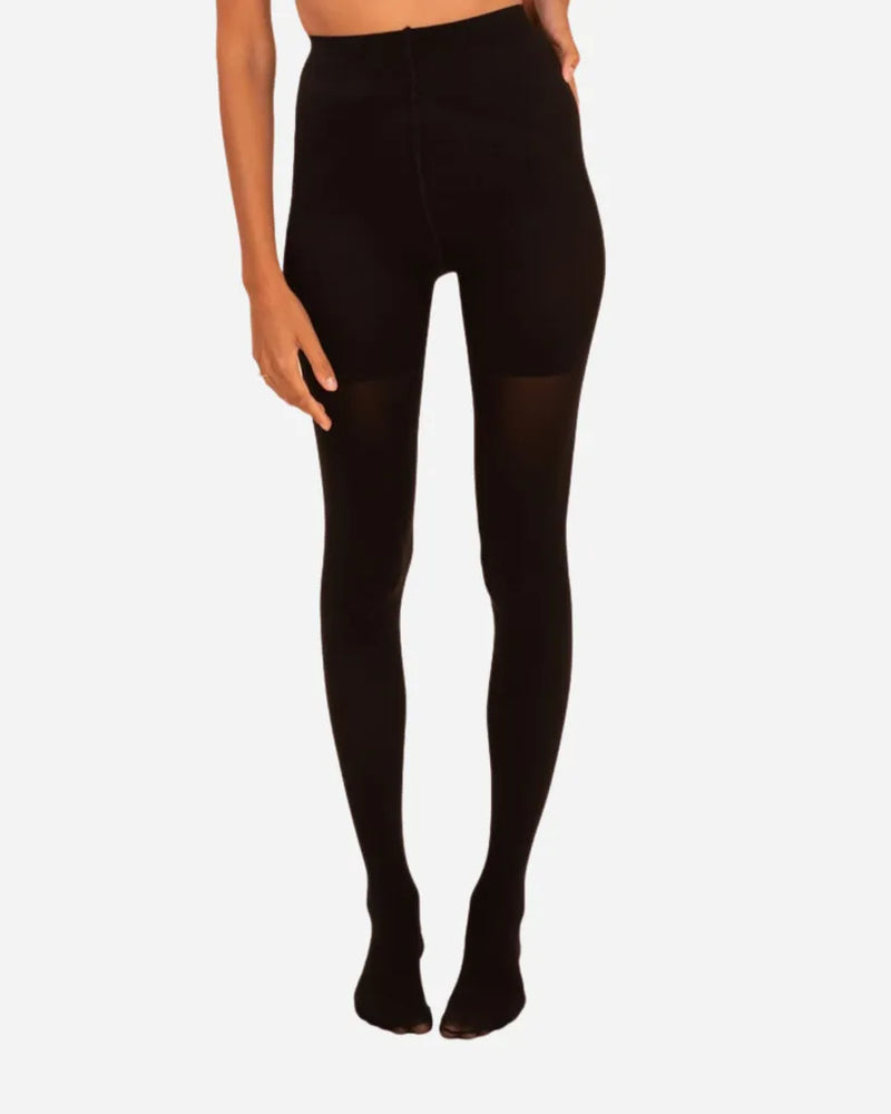 Front view of woman in opaque black tights with a high-waist contour panel. Threads Opaque Contour Black Tights.