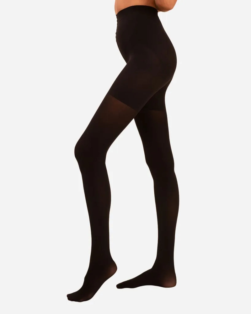 Side view of woman in opaque black tights with a contour waistband. Threads Opaque Contour Black Tights.