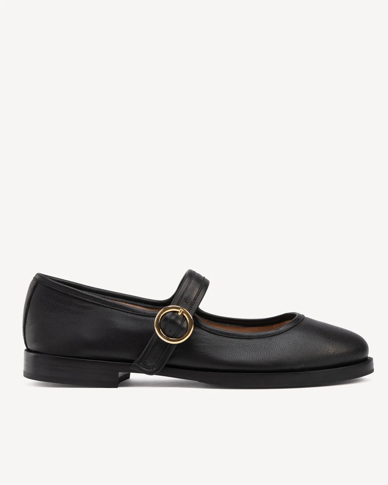 Side view of round-toe flat with single buckle strap. The Today Mary Jane Black. Sizes 5–12, wide available.