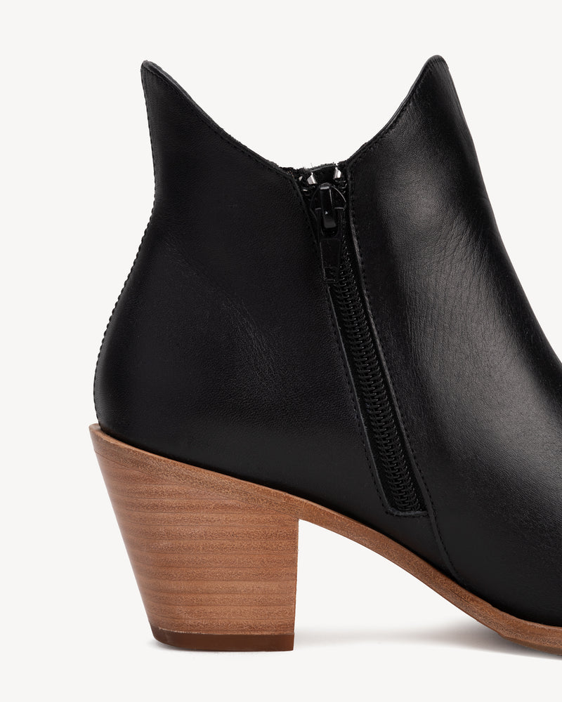 Close-up of zipper pull and topline edge. The Two Point Five Ankle Boot Black Water Resistant. Sizes 5–12, wide available.