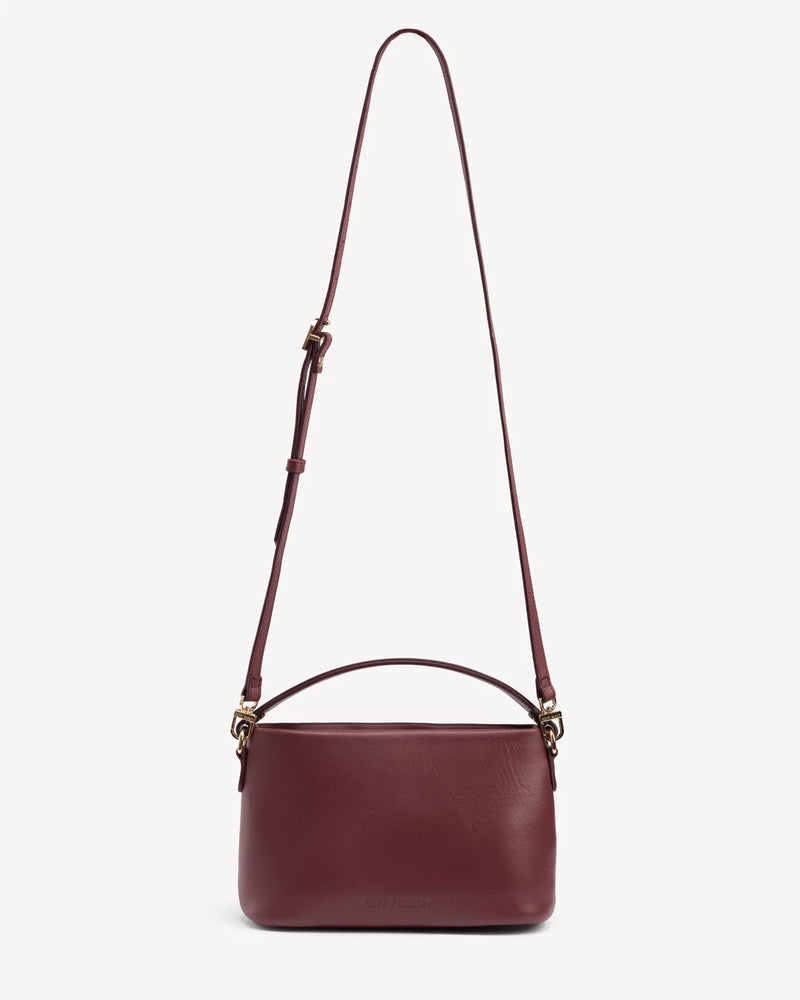 Rectangular crossbody bag with looped top handle and long adjustable strap. The Via Monte Bag Compote.