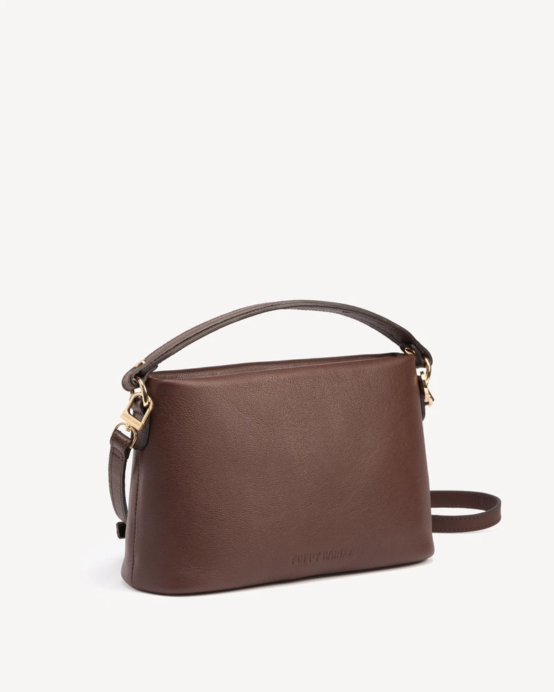 Angled view of rectangular bag showing structured silhouette and handle. The Via Monte Bag French Press.