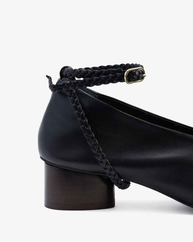 Close-up of the braided ankle strap and buckle on a leather pump. The Alma Anklet Pump Black. Sizes 5–12.