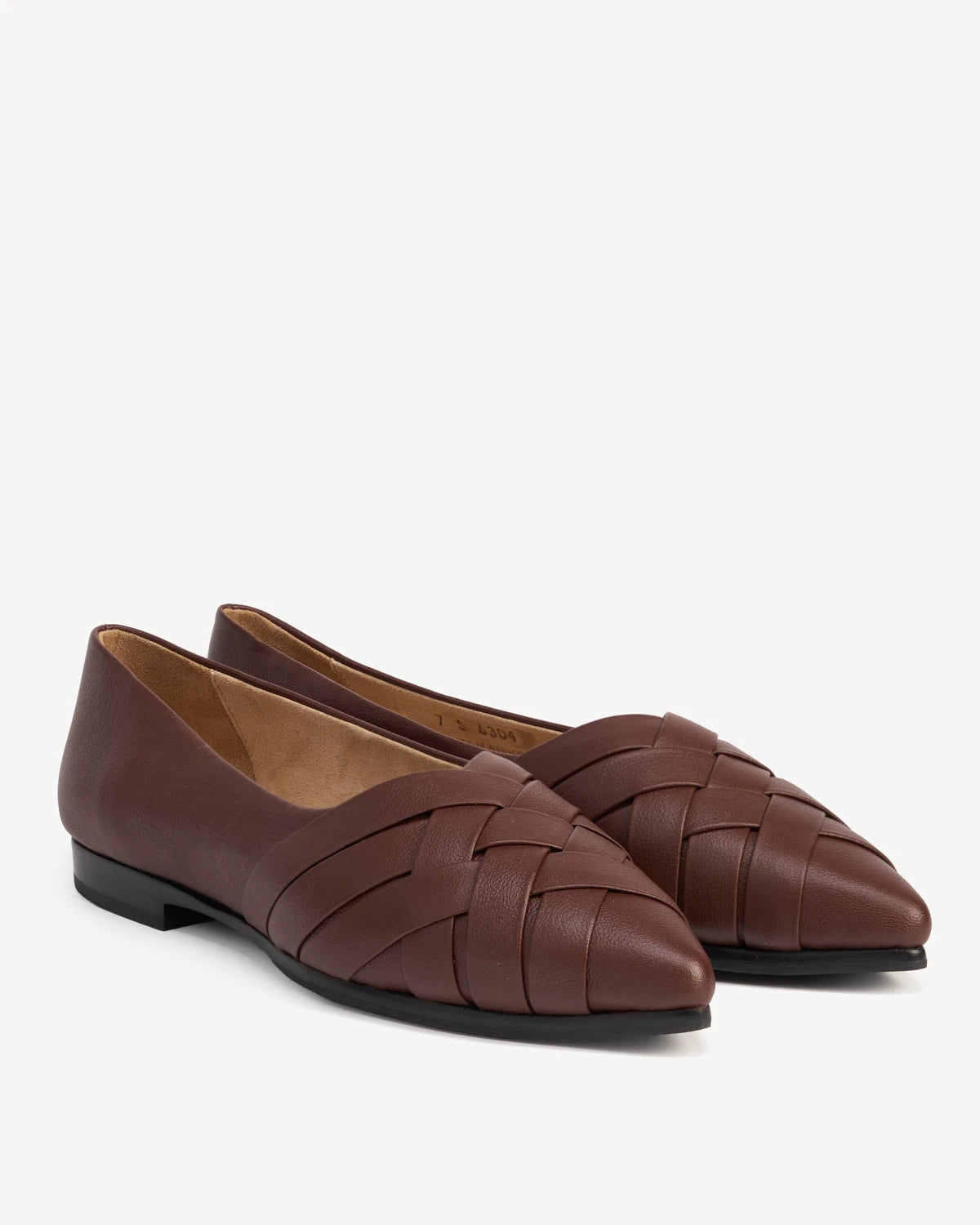 Pair of woven leather flats with pointed toes, angled view. The Athena Flat French Press. Sizes 5–12, wide available.
