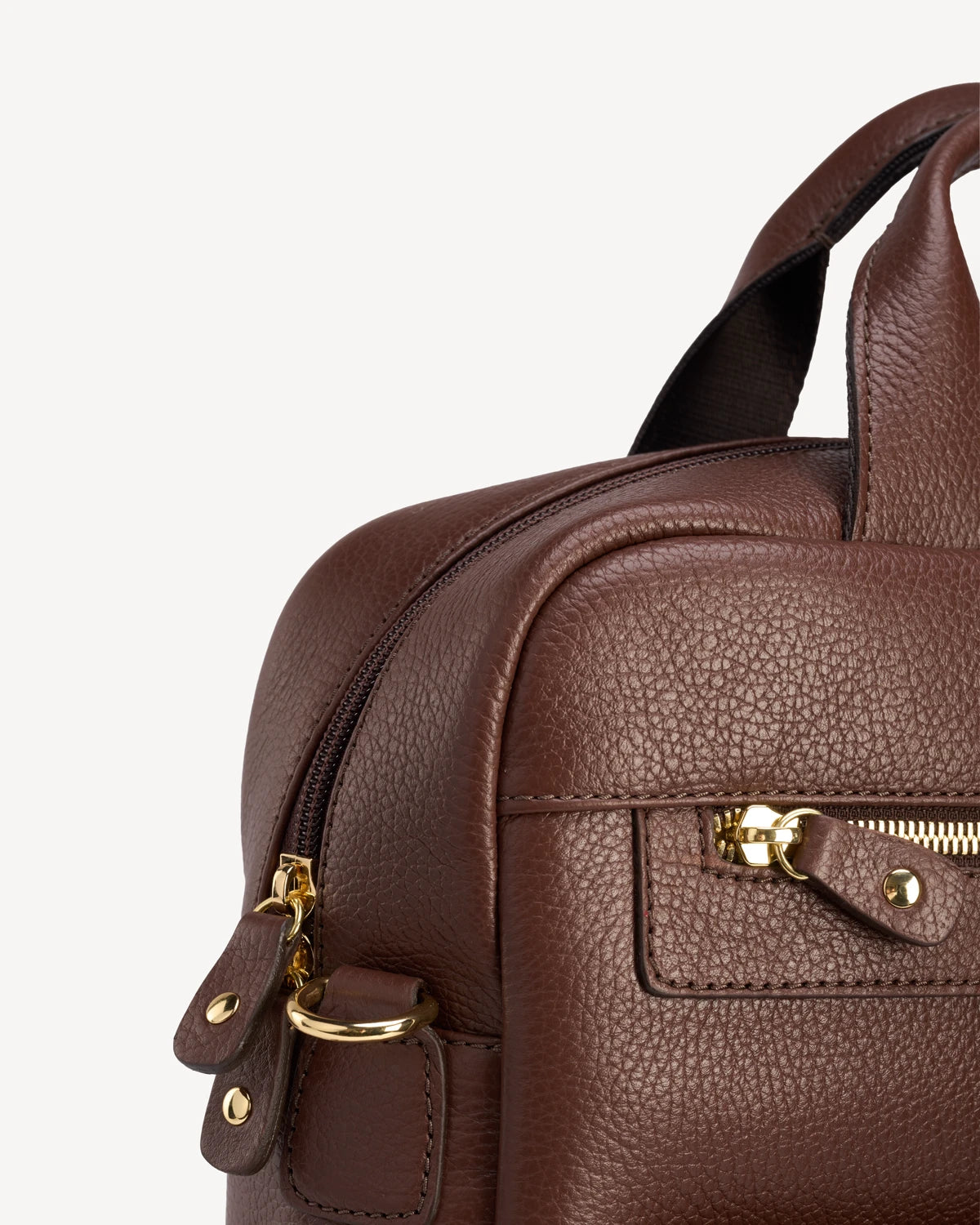 Close-up of hardware and zip pull on the pebbled-leather backpack. The Backpack French Press.