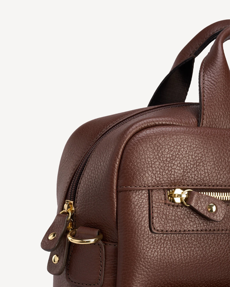 Close-up of hardware and zip pull on the pebbled-leather backpack. The Backpack French Press.