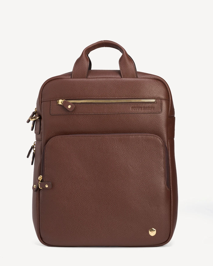 Front view of the pebbled-leather backpack with top handle and zip pockets. The Backpack French Press.
