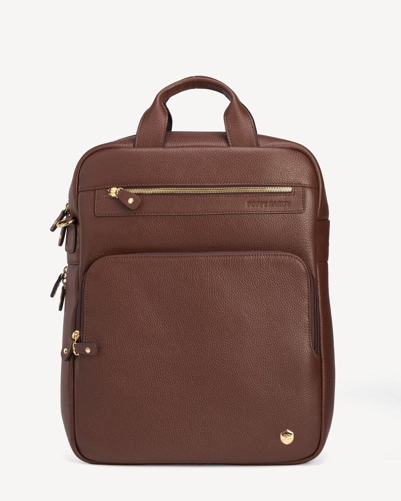Front view of the pebbled-leather backpack with top handle and zip pockets. The Backpack French Press.