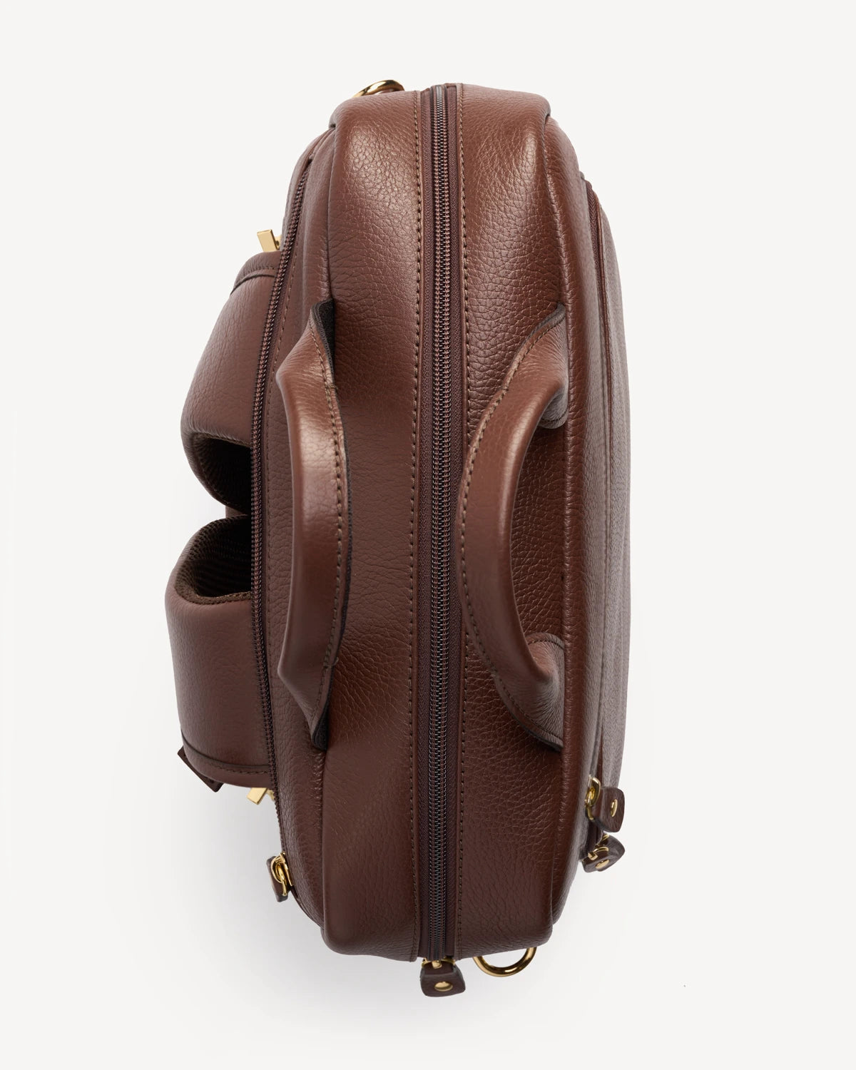 Side profile of the pebbled-leather backpack showing its rounded silhouette. The Backpack French Press.