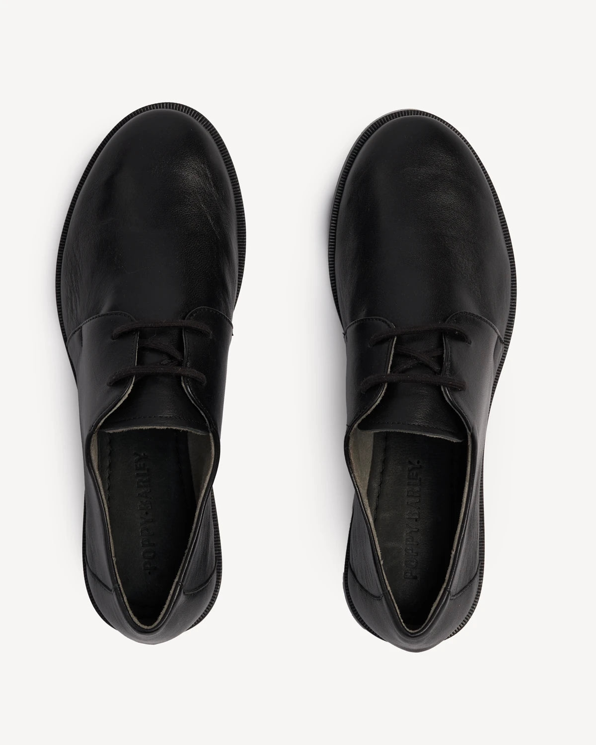 Overhead view of a pair of lace-up oxfords. The Capsule Oxford Black. Sizes 5–12, wide available.