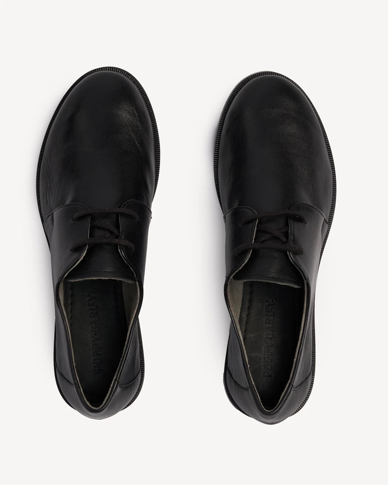Overhead view of a pair of lace-up oxfords. The Capsule Oxford Black. Sizes 5–12, wide available.
