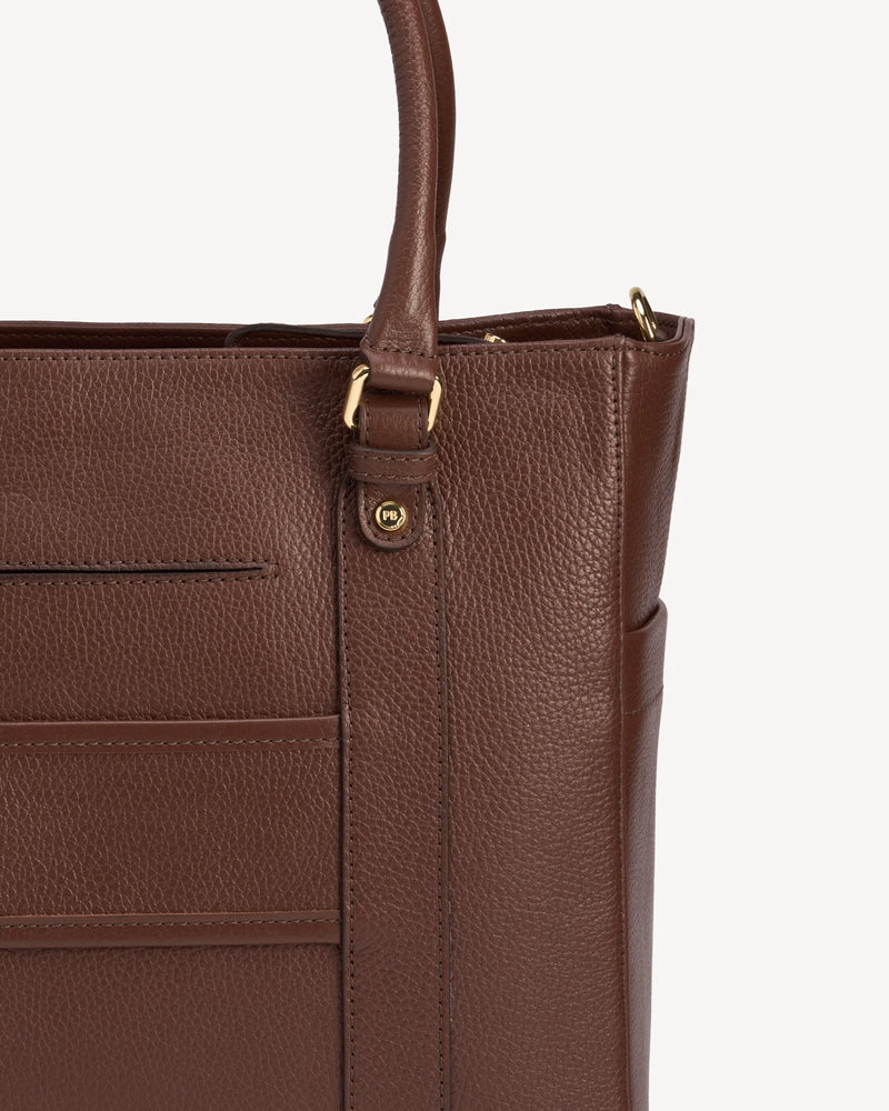 Close-up of exterior slip pockets and zip closure on the leather tote. The Colleague Tote French Press.