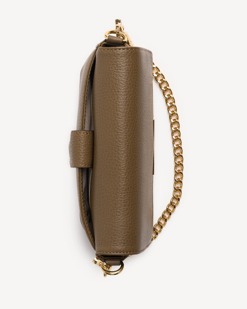Side view of the leather flap bag showing chain strap and flap closure. The Day To Night Bag Tapenade.