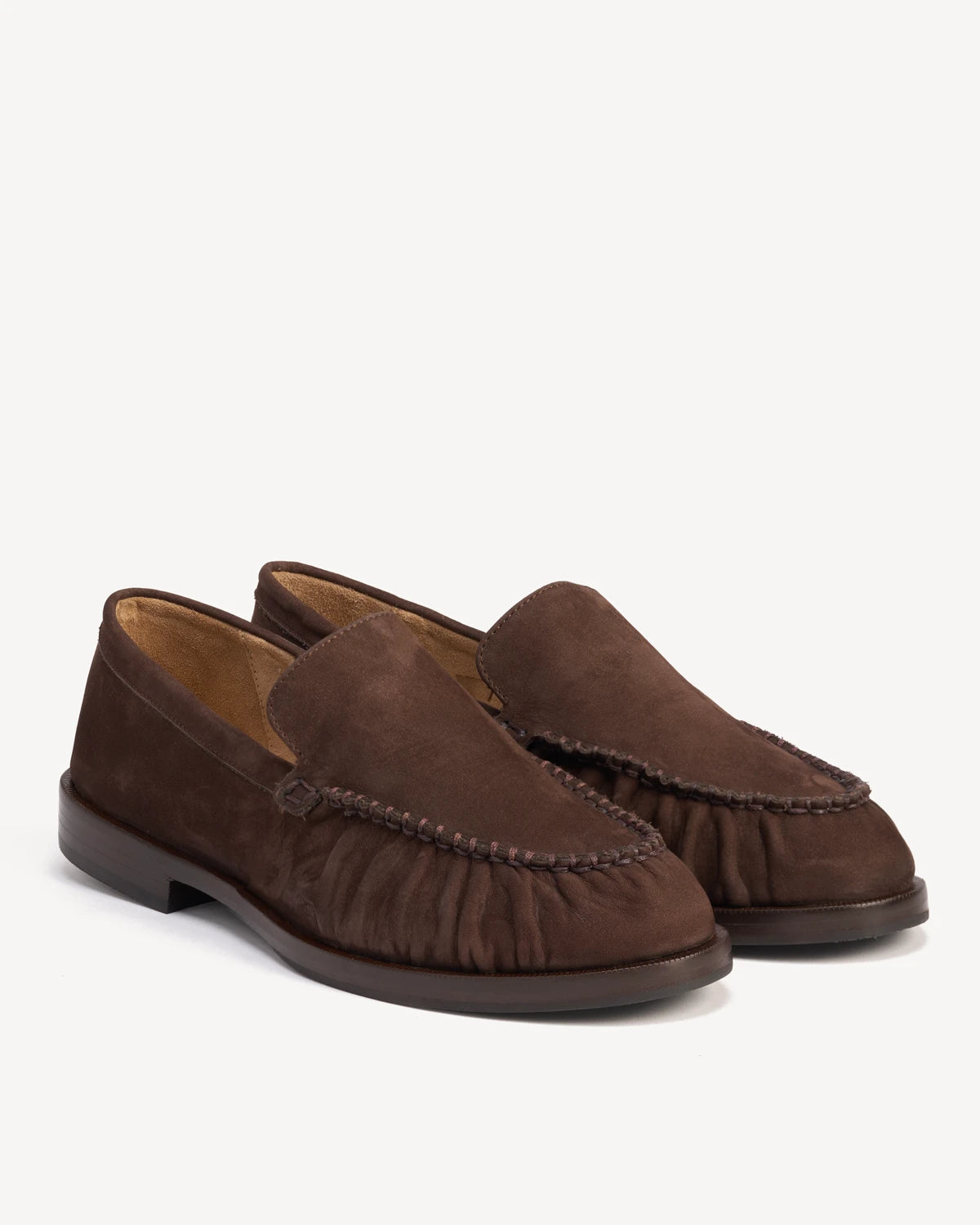 Pair of suede loafers with ruched apron detail, angled view. The Laid Back Loafer Cocoa Plum. Sizes 5–12, wide available.