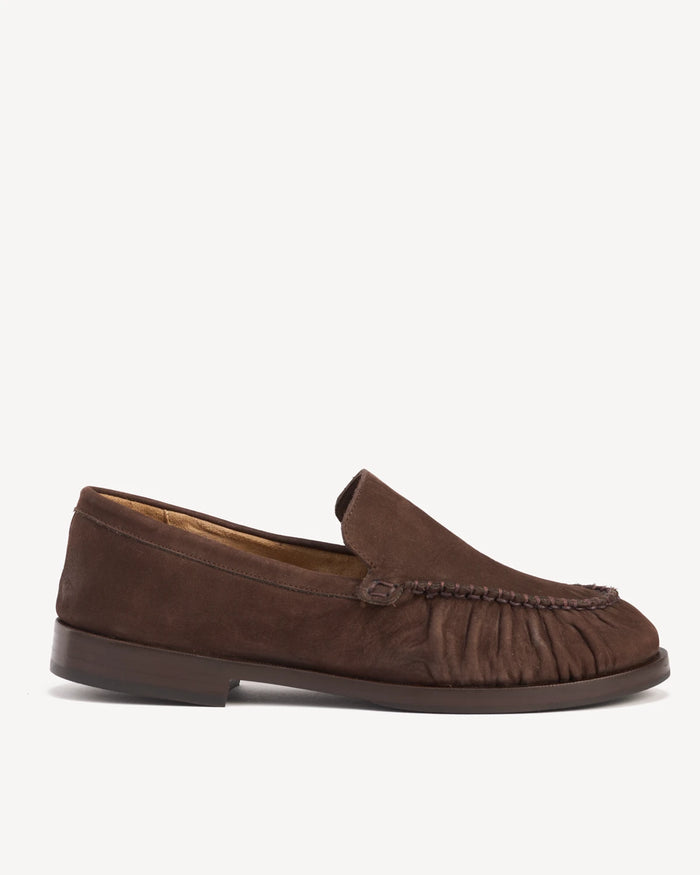 Side view of a suede loafer with ruched apron and low heel. The Laid Back Loafer Cocoa Plum. Sizes 5–12, wide available.