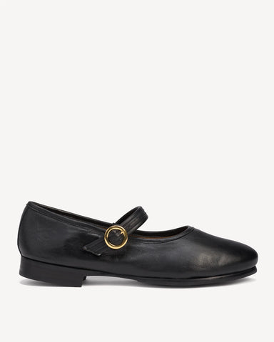 Side view of a leather Mary Jane flat with round toe and ankle strap. The Modern-Day Mary Jane Blackout. Sizes 5–12.