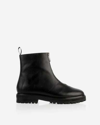 Side view of a leather boot with front zip and chunky lug sole. The Montreal Zip Boot Black WR. Sizes 5–12.