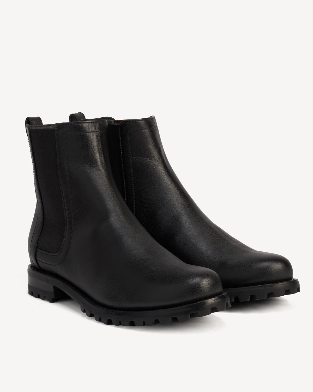 Pair of Chelsea boots at a front angle. The On Tread Chelsea Boot Black Water Resistant. Sizes 5–12, wide available.