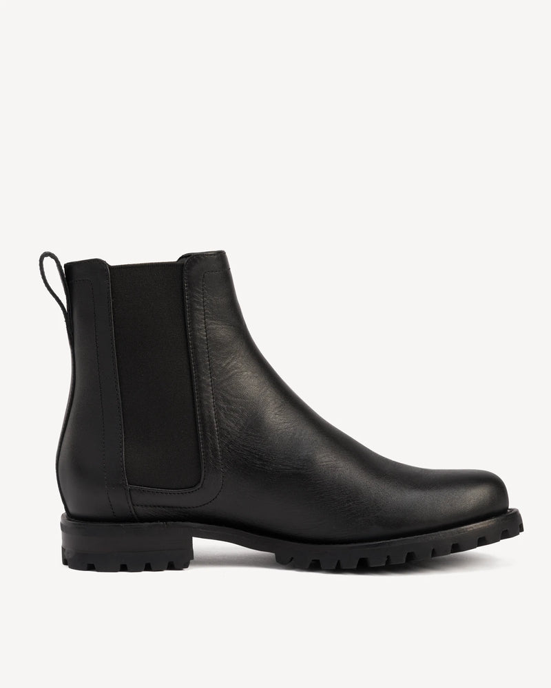 Side view of a leather Chelsea boot. The On Tread Chelsea Boot Black Water Resistant. Sizes 5–12, wide available.