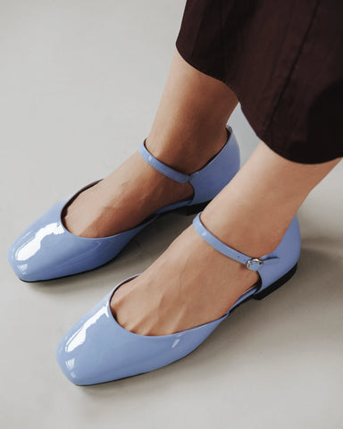 Side profile in glossy patent leather with d'orsay cut, square toe. The Gallery Mary Jane Cornflower Patent. Sizes 5–12.