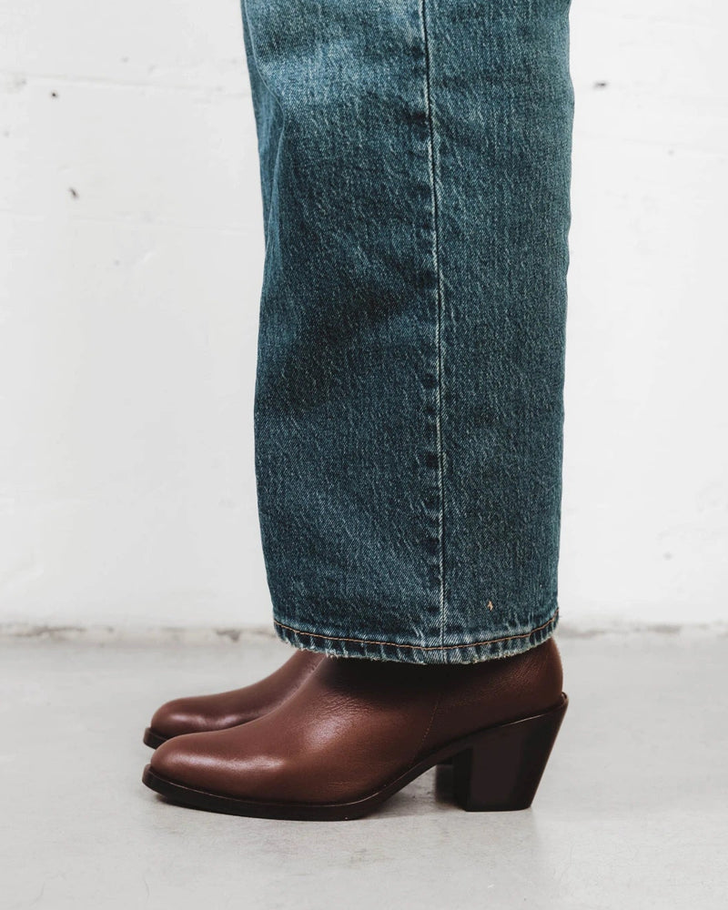 Close-up of an ankle boot worn with cropped denim. The Two Point Five Ankle Boot French Press. Sizes 5–12, wide available.