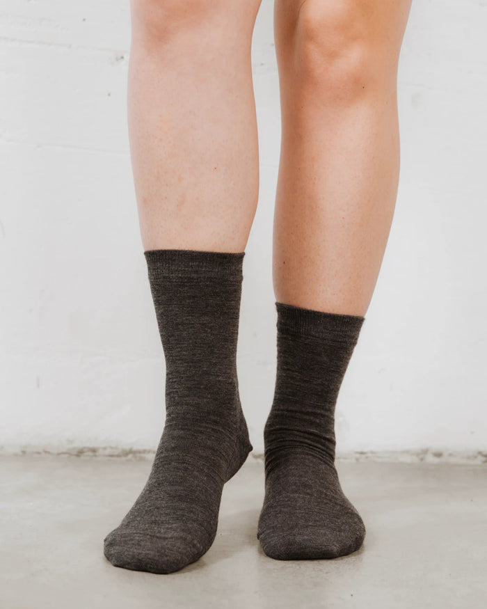 On-foot view of slouchy crew socks in a heathered wool-blend knit. The Dressy Crew Sock Charcoal Melange.