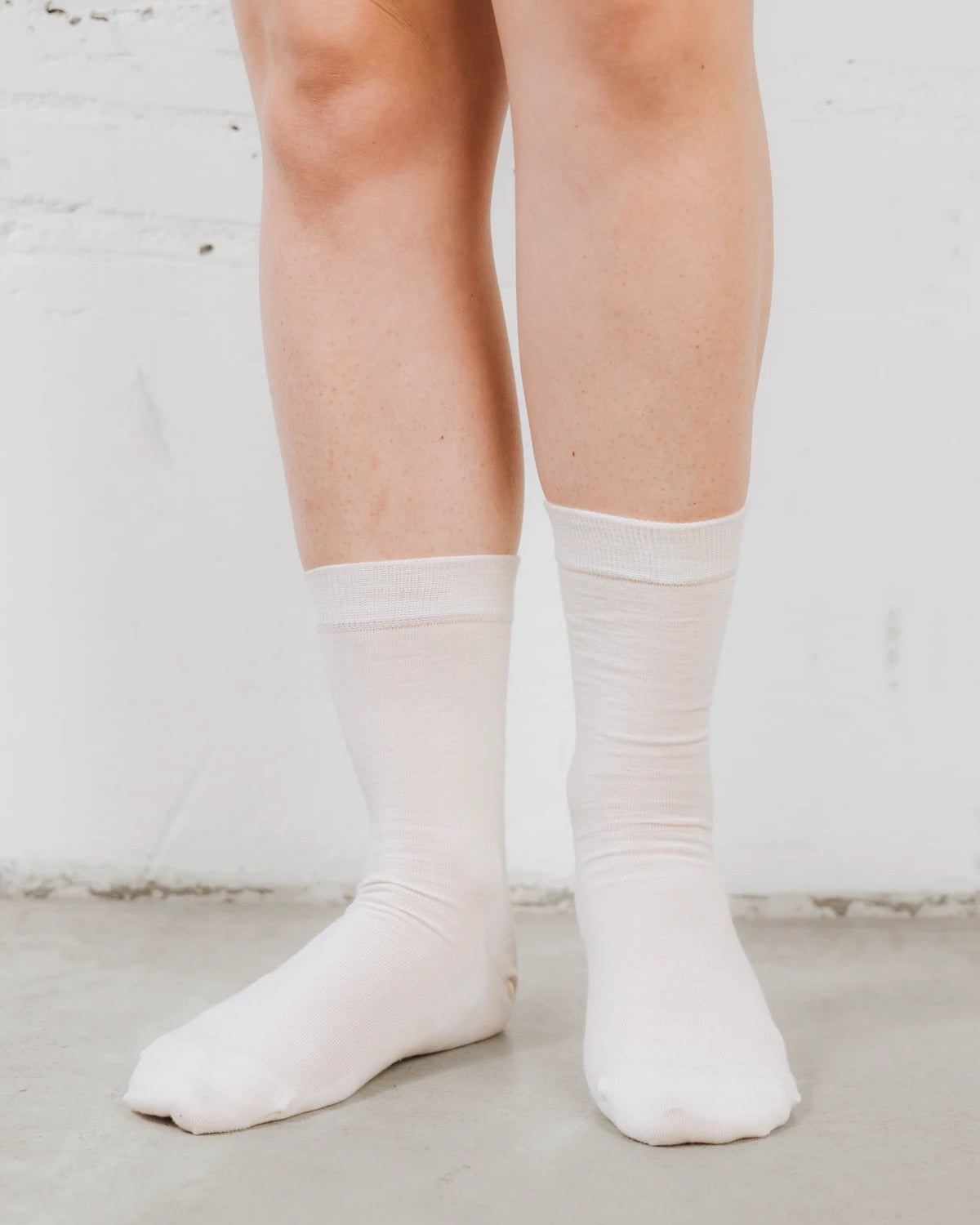 On-foot view of ribbed crew socks in a soft wool-blend knit. The Dressy Crew Sock Alabaster 3-Pack.