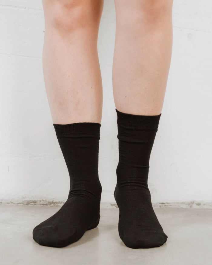 Front view of crew-length socks with a ribbed cuff, soft wool knit. The Dressy Crew Sock Black 3-Pack.