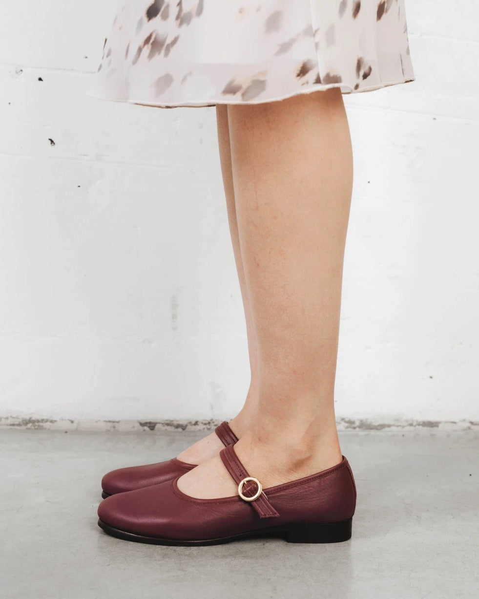 Close-up of a mary jane flat worn with a printed skirt. The Modern-Day Mary Jane Compote. Sizes 5–12, wide available.