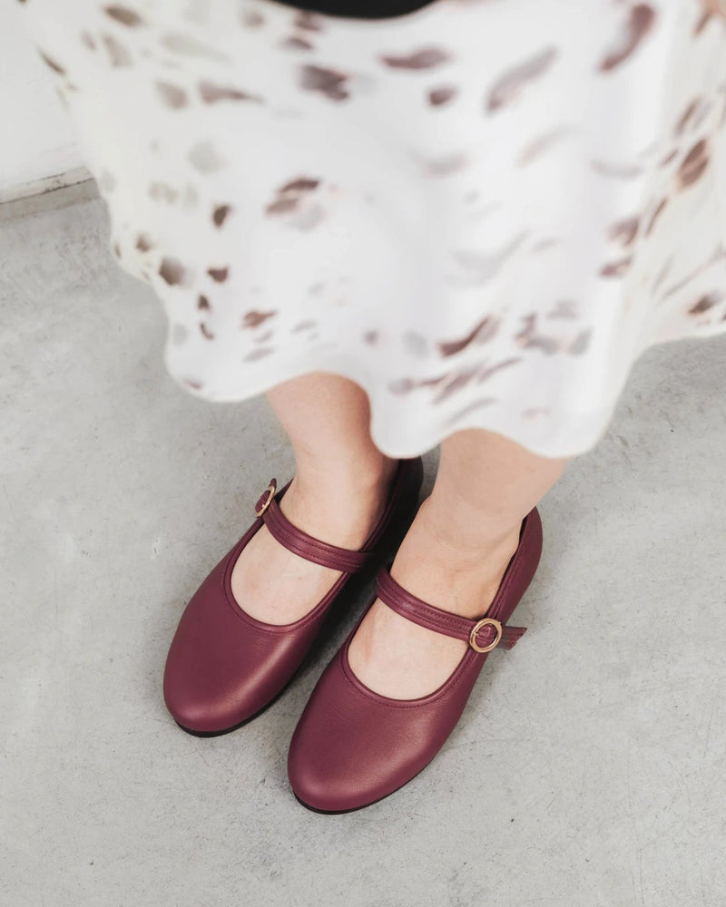Close-up of mary jane flats worn with a floral midi skirt. The Modern-Day Mary Jane Compote. Sizes 5–12, wide available.