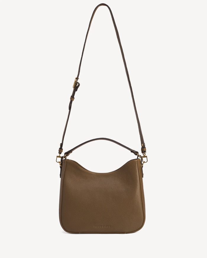 Front view of the leather hobo bag with a long adjustable strap laid flat. The Sixteenth Tote Tapenade.