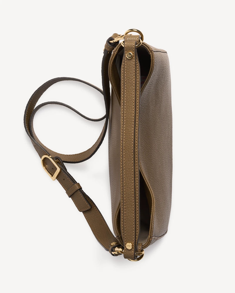 Leather hobo bag lying flat showing zip closure and adjustable strap. The Sixteenth Tote Tapenade.