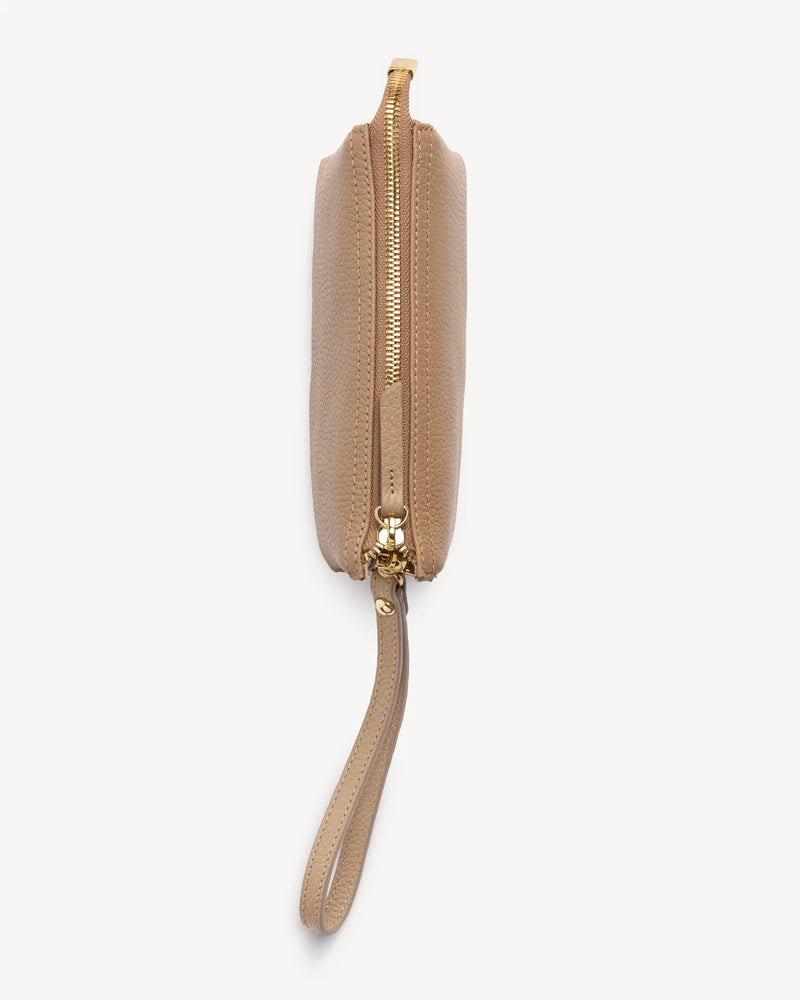 Side profile of the pebbled-leather wristlet showing zipper and wrist strap. The 3-in-1 Wristlet Biscotti Pebble.